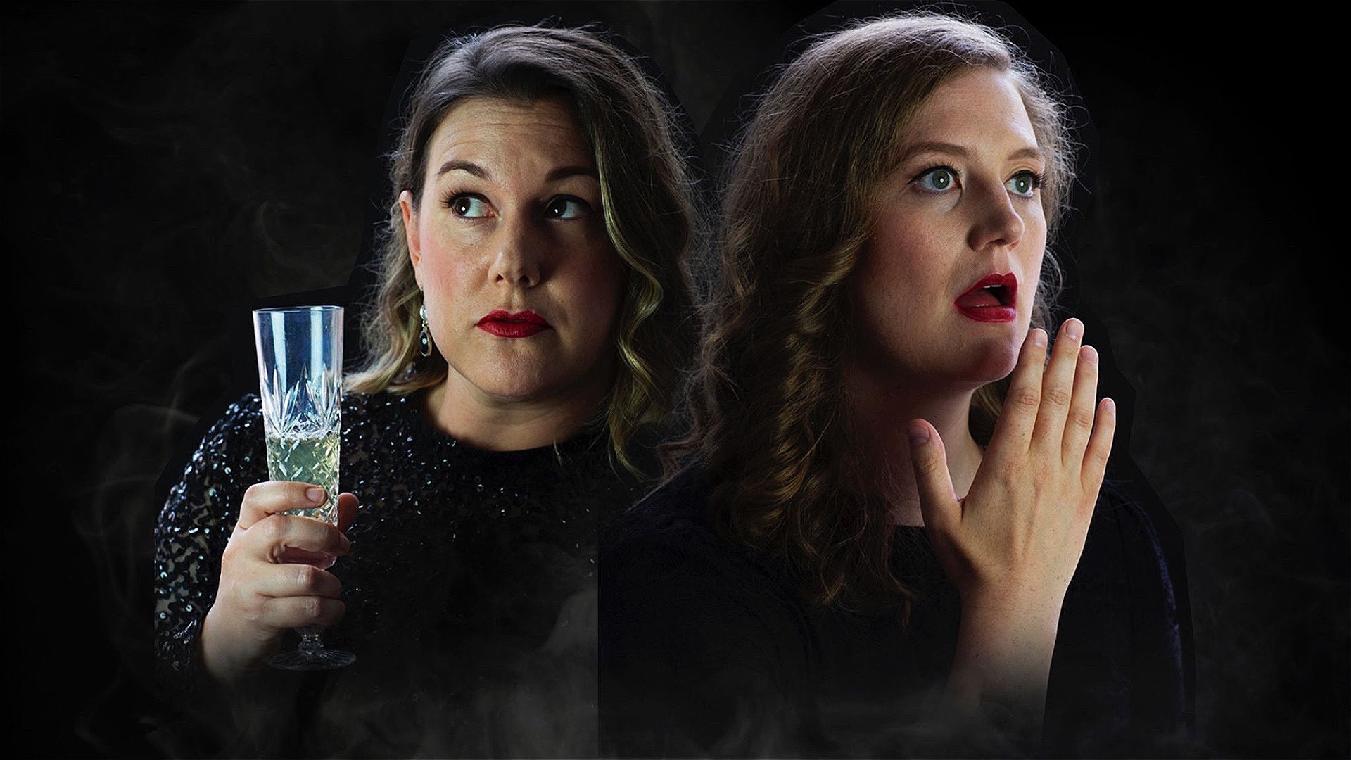 Two women are stood in the middle of the frame, one is holding a glass of Prosecco, one is holding her hand to her mouth in shock. Both wearing back in front of a black background.